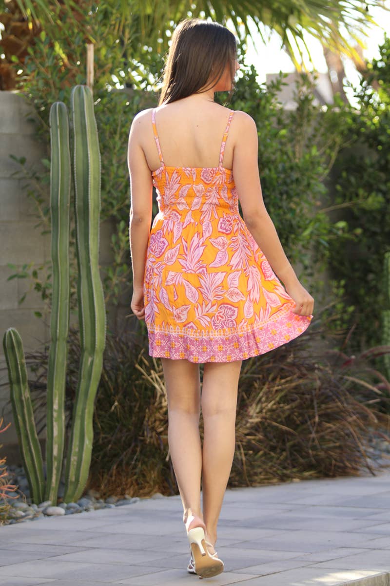 Back view of ANGIE V neck sundress beachwear with floral design, perfect for warm weather outings